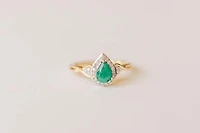 Halo Ring with .17 Carat TW of Diamonds and 7x5MM Pear Shape Emerald in 10kt Yellow Gold