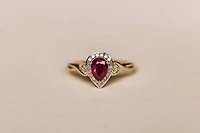 Halo Ring with .17 Carat TW of Diamonds and 7x5MM Pear Shape Ruby in 10kt Yellow Gold