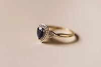 Halo Ring with .17 Carat TW of Diamonds and 7x5MM Pear Shape Blue Sapphire in 10kt Yellow Gold