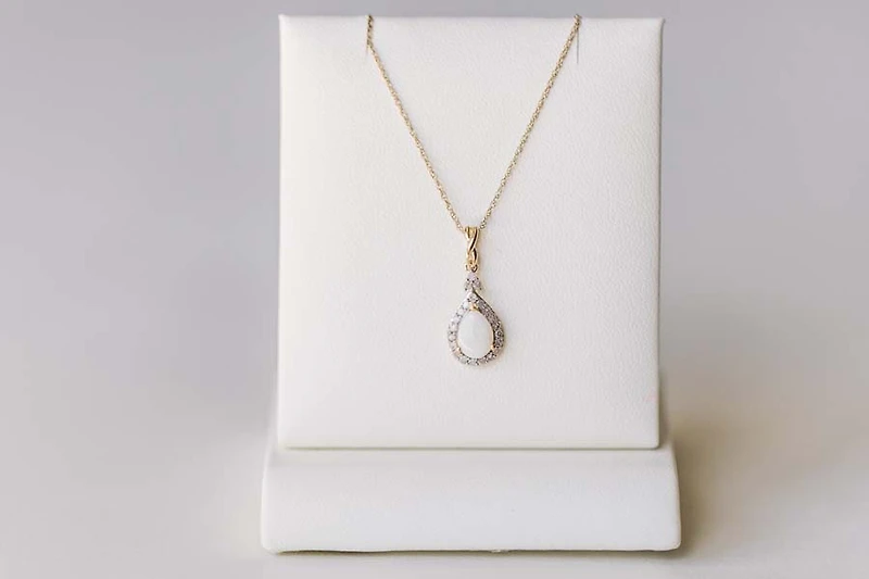 Halo Pendant with .13 Carat TW of Diamonds and 7x5MM Pear Shape Opal in 10kt Yellow Gold with Chain