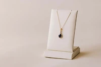 Halo Pendant with .13 Carat TW of Diamonds and 7x5MM Pear Shape Blue Sapphire in 10kt Yellow Gold with Chain