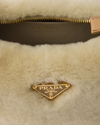 Prada Arqué shearling and leather shoulder bag