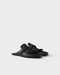 Shuffle antiqued leather mules with buckled strap and fringe