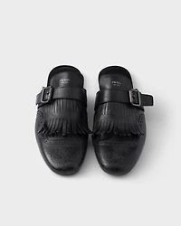Shuffle antiqued leather mules with buckled strap and fringe