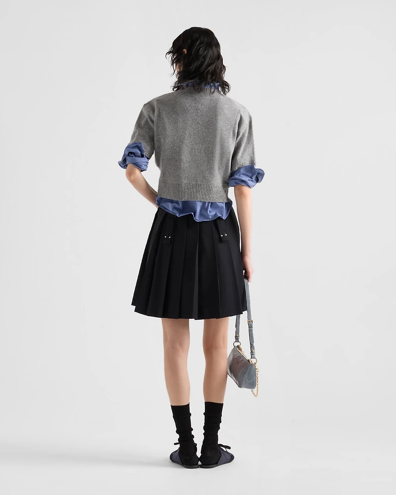 Pleated gabardine miniskirt with metal rings