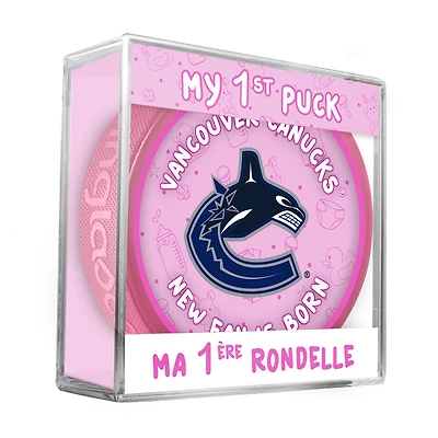 Logo du nouveau fan des Vancouver Canucks de la LNH sur une rondelle rose dans un cube