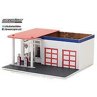 <br>1:64 Coin du mécanicien - Séries 2 - Les couleurs et les motifs peuvent varier - une par commande