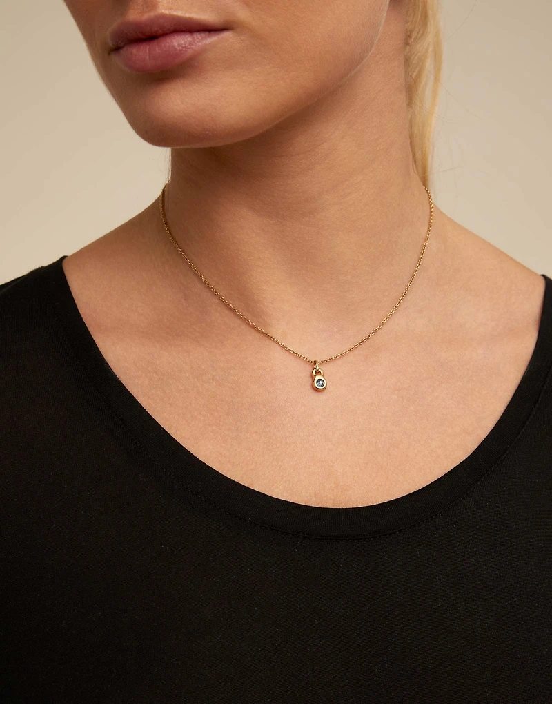 Round shaped Charm with a blue crystal