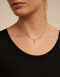 Round shaped Charm with a blue crystal