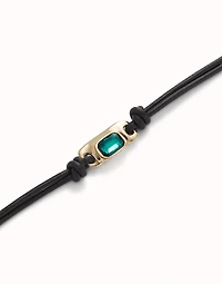 Leather bracelet with a green crystal