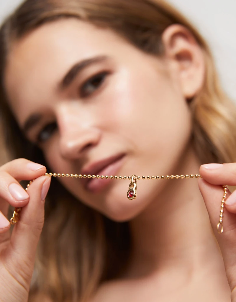 Charm with red crystal