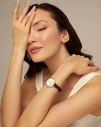 Sterling silver-plated watch with black leather strap and round white dial