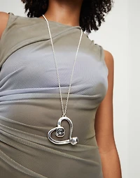 Long chain pendant necklace with a large heart