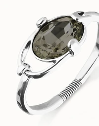 Bangle bracelet with oval faceted gray crystal