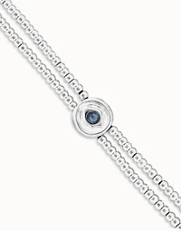 Two-strand beaded bracelet with an eye-shaped charm