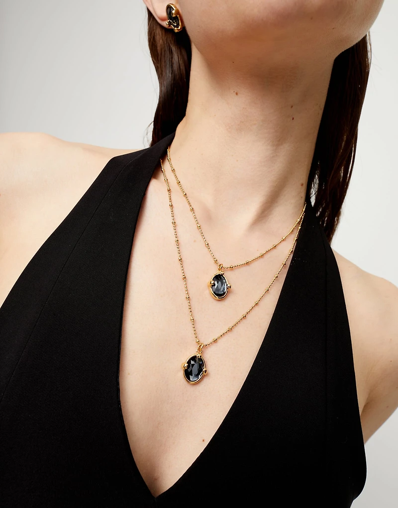 Multi strand necklace with two black oval faceted crystals
