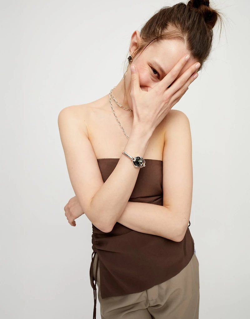 Bangle bracelet with oval faceted gray crystal