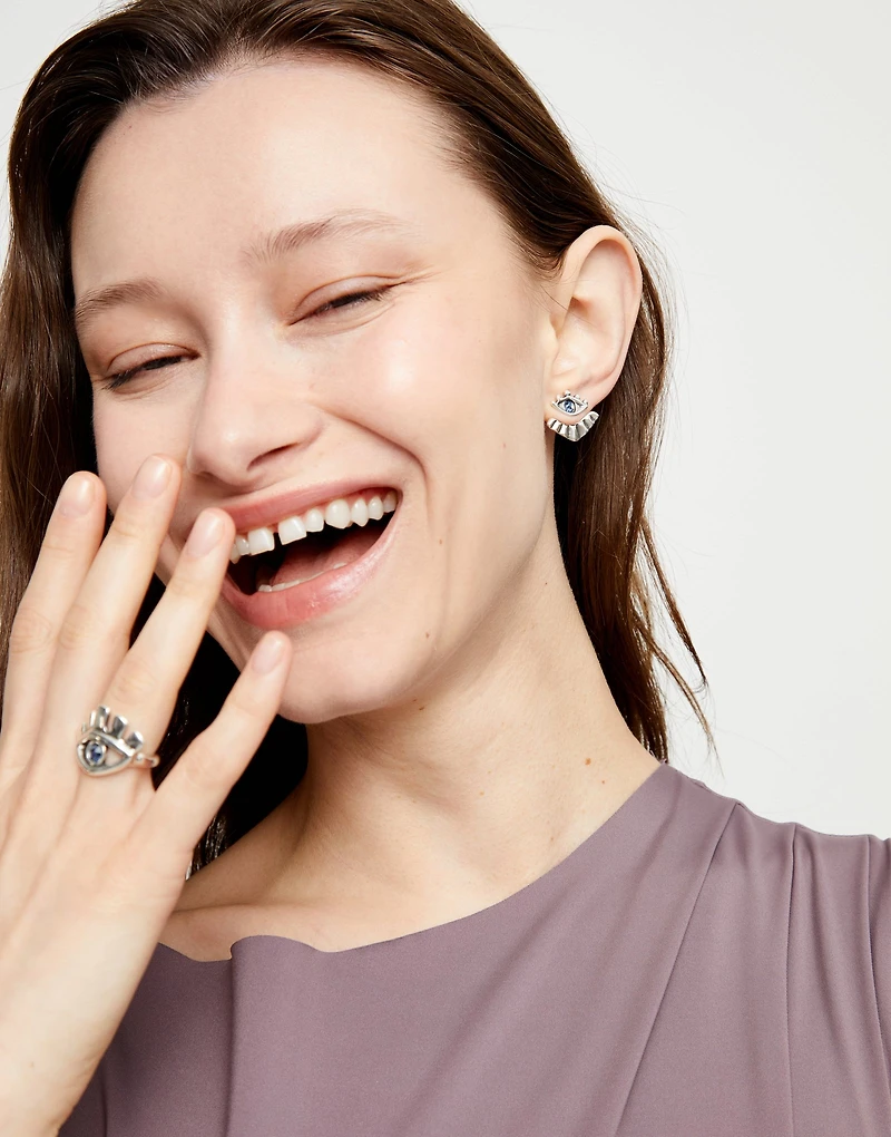 Eye-shaped stud earrings with blue crystal