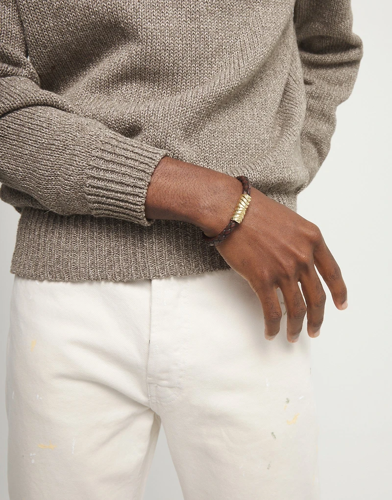 Brown braided leather bracelet with a metal detail
