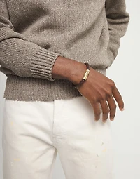 Brown braided leather bracelet with a metal detail