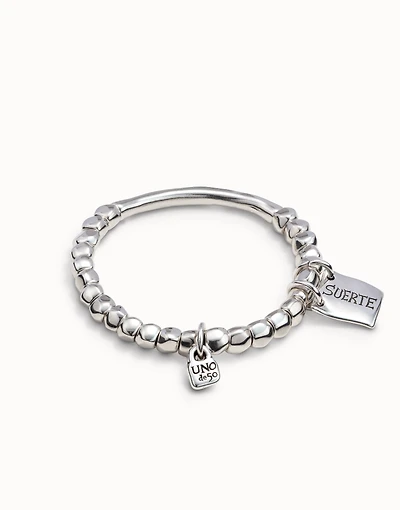 Beaded stretch bracelet with tubular piece and a charm