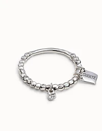 Beaded stretch bracelet with tubular piece and a charm