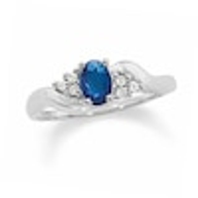 Oval Blue Sapphire and 1/20 CT. T.w. Diamond Twist Ring in 10K White Gold