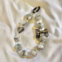 Vogue Strap: Marble Bead Bow Charm Bracelet Phone Accessory (Color Ships Assorted)