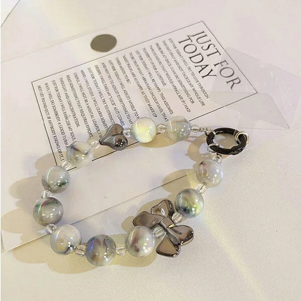 Vogue Strap: Marble Bead Bow Charm Bracelet Phone Accessory (Color Ships Assorted)