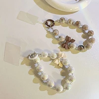 Vogue Strap: Marble Bead Bow Charm Bracelet Phone Accessory (Color Ships Assorted)