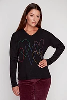 Le pull à motif coeurs colorés