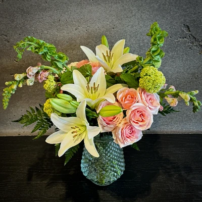 Delicate bouquet of white lilies and soft pink roses