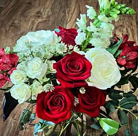 Elegant red roses intertwined with delicate white blooms