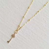 Minerva Tiny Key Charm Gold Necklace