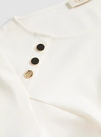 Haut péplum à boutons décoratifs