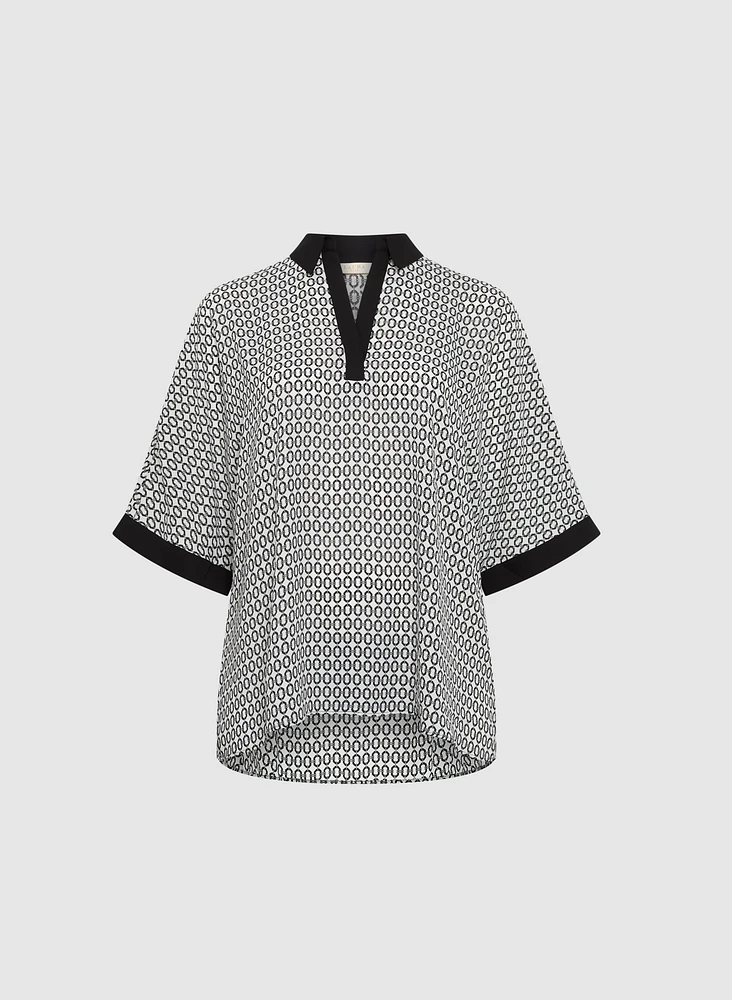 Blouse contrastante à motif géométrique