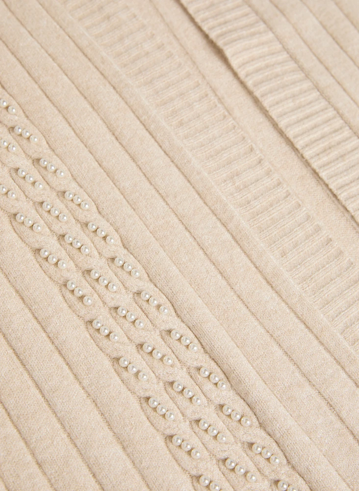 Cardigan à mailles torsadées et perles