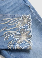 Jean à jambe droite et broderies