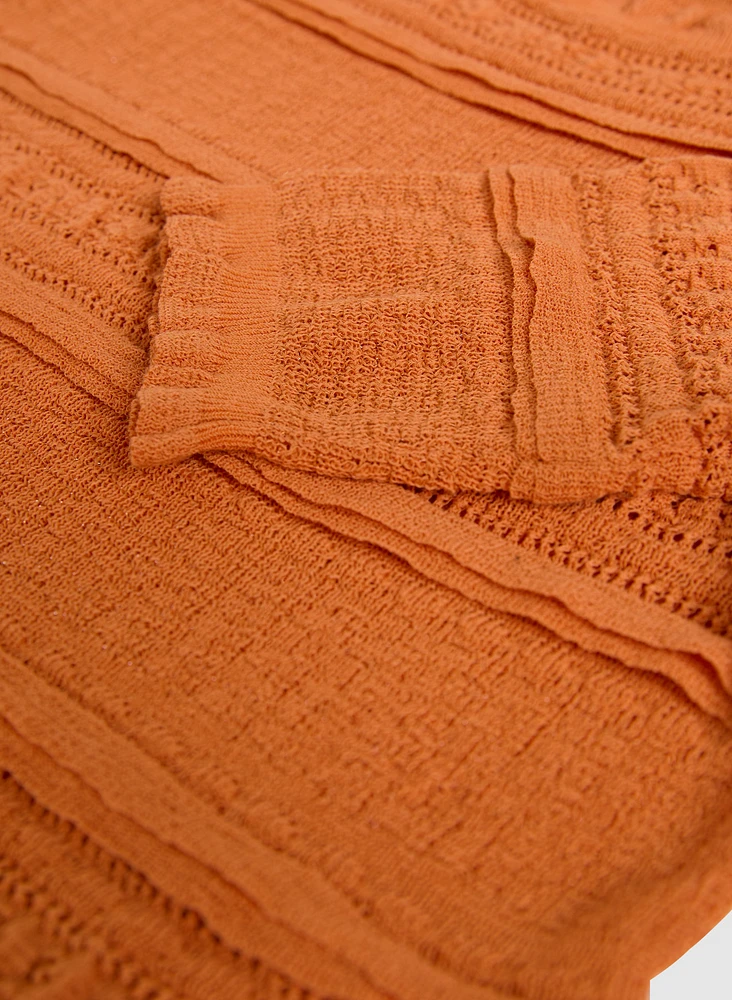 Pull en tricot à ourlet ondulé