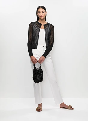 Cardigan en tricot avec chaîne et jean à taille haute