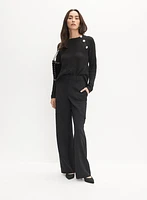 Pull asymétrique à boutons fantaisie
