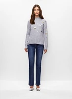 Pull à étoiles et jean à jambe droite