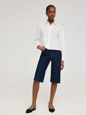 Blouse en coton boutonnée sur le devant avec boucles