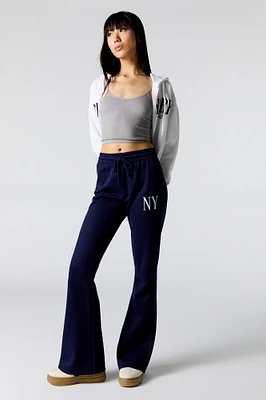 Pantalon d'entraînement à jambe évasée en molleton avec motif brodé