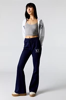 Pantalon d'entraînement à jambe évasée en molleton avec motif brodé