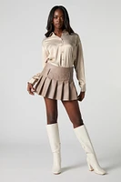 Mini jupe-short à plis en similicuir