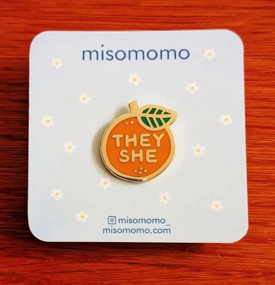 Pronoun Orange pin They/She