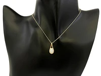 10K Yellow Gold 7x5mm Oval Cut White Opal and 0.08cttw Diamond Halo Pendant - 18 Inches