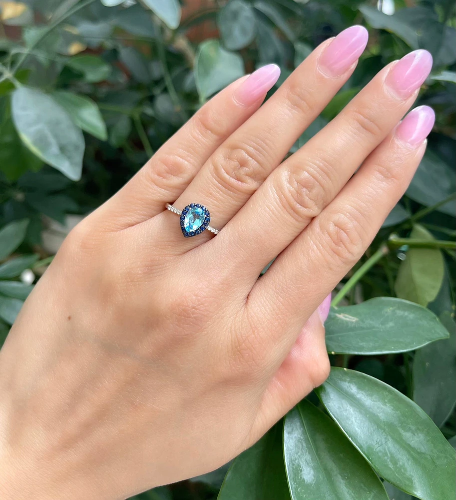 10K White Gold 7x5mm Pear Cut Sky Blue Topaz with Blue Sapphire Halo and 0.10cttw Diamond Ring - Size 7