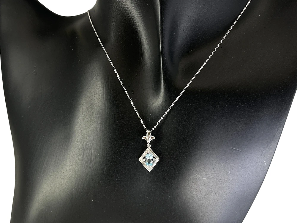10K White Gold 6x4mm Oval Cut Sky Blue Topaz and 0.021cttw Diamond Necklace - 18 Inches